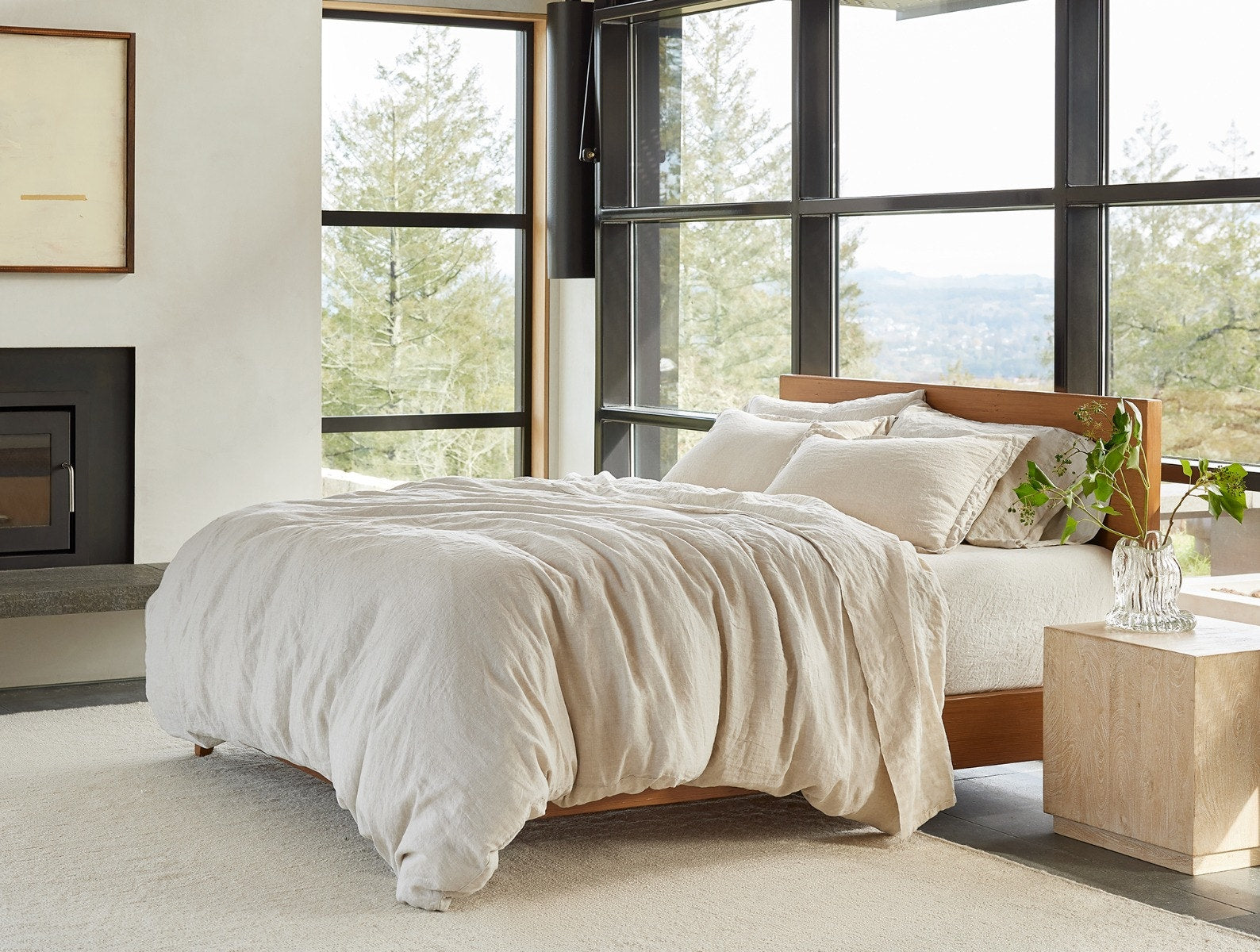 Coyuchi Organic Relaxed Linen Sheet Set in Natural Chambray – styled on bed in natural light by window. #colour_natural chambray