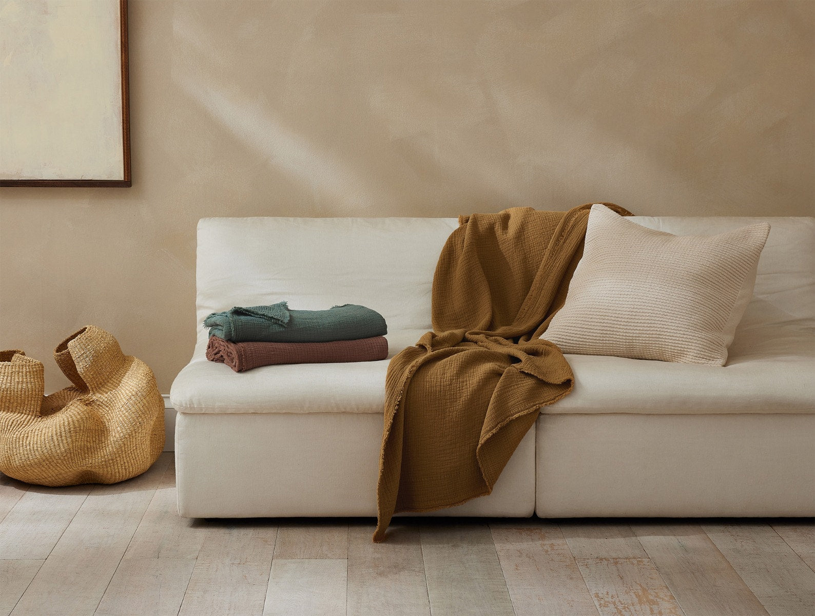 Coyuchi Topanga Organic Cotton Matelasse Throw - draped over couch #colour_Hazel