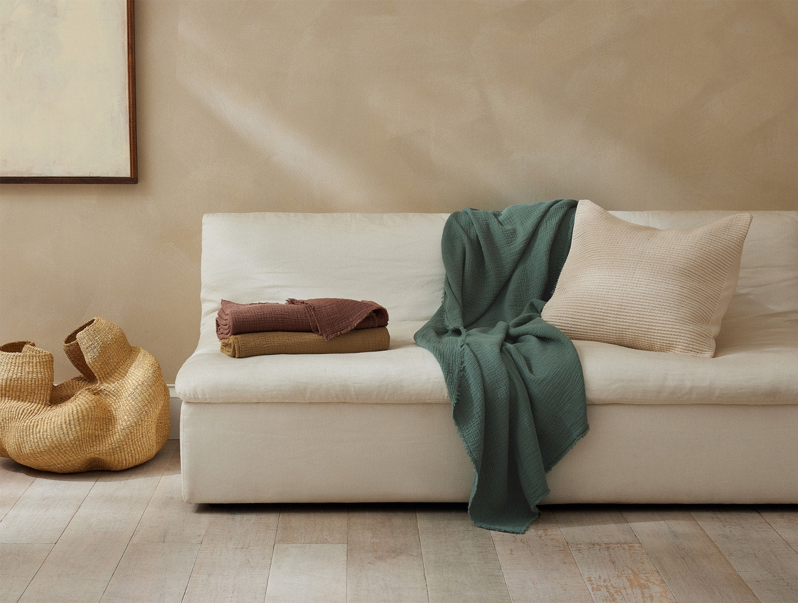 Coyuchi Topanga Organic Cotton Matelasse Throw - draped over couch relaxed #colour_juniper
