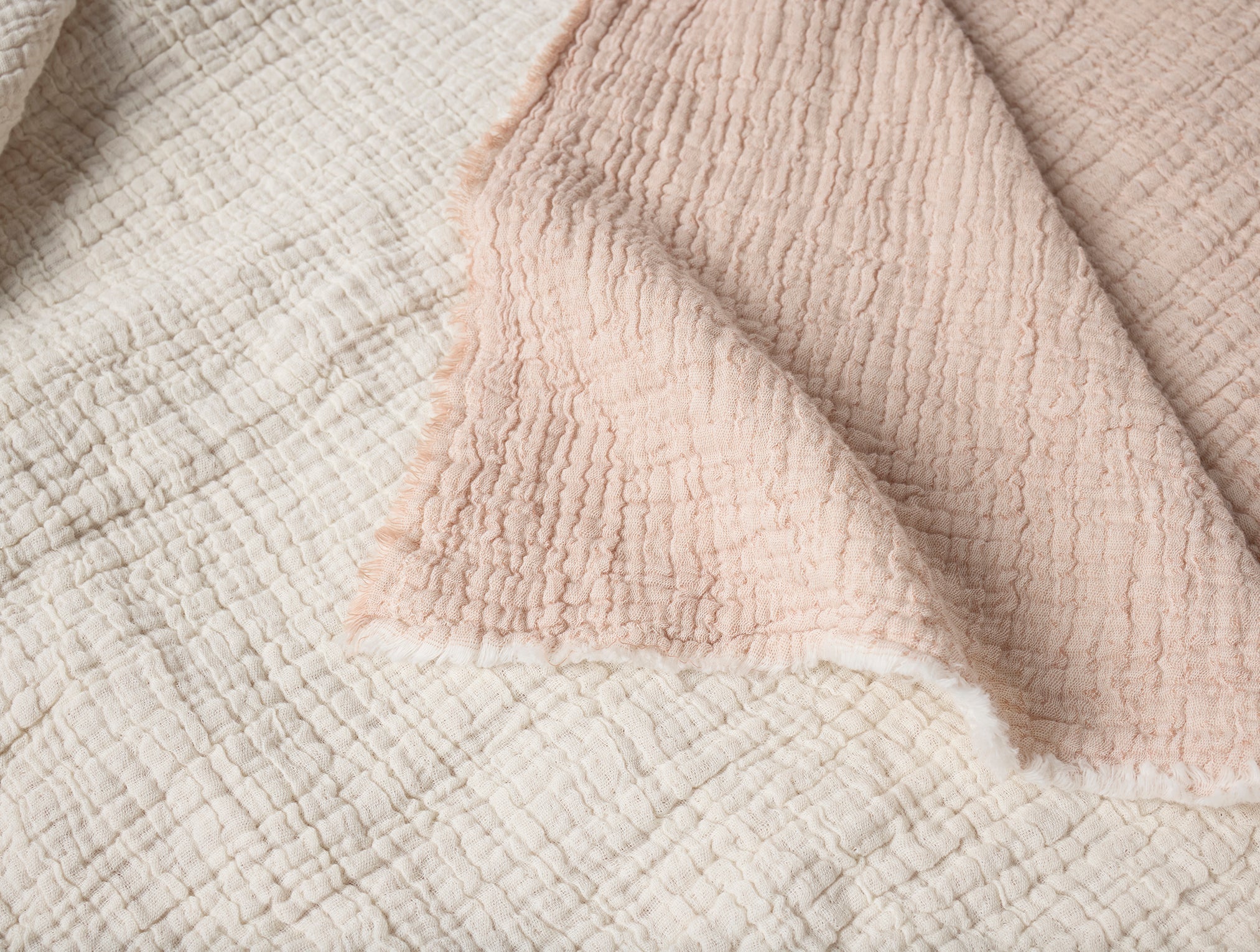 Coyuchi Topanga Organic Matelasse Blanket - close up corner folded over to show under colour #colour_praline chambray