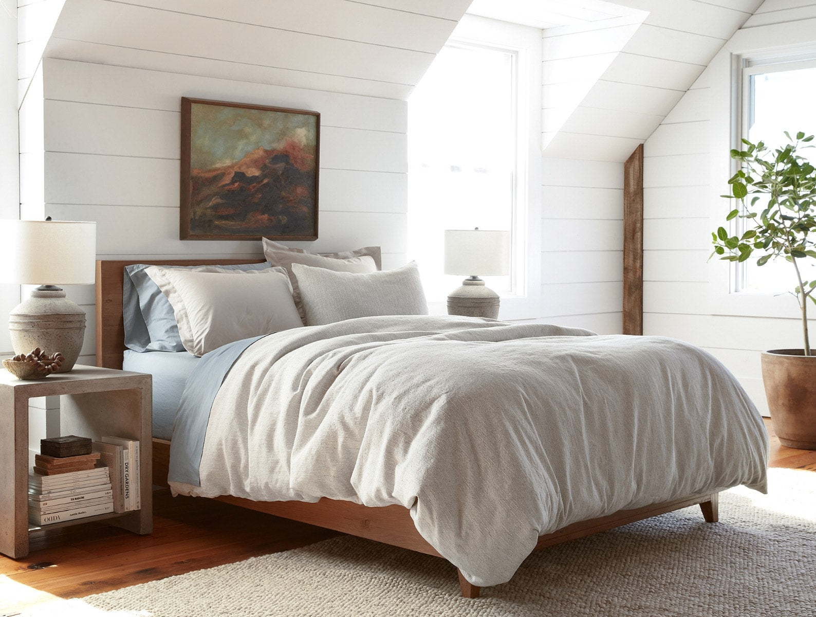 Coyuchi Toro Canyon Organic Duvet Cover - staged bed on wood frame with painting above #colour_sterling