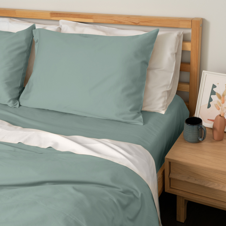 Homebird Organic Sateen Flat Sheet -staged bed angled #colour_green