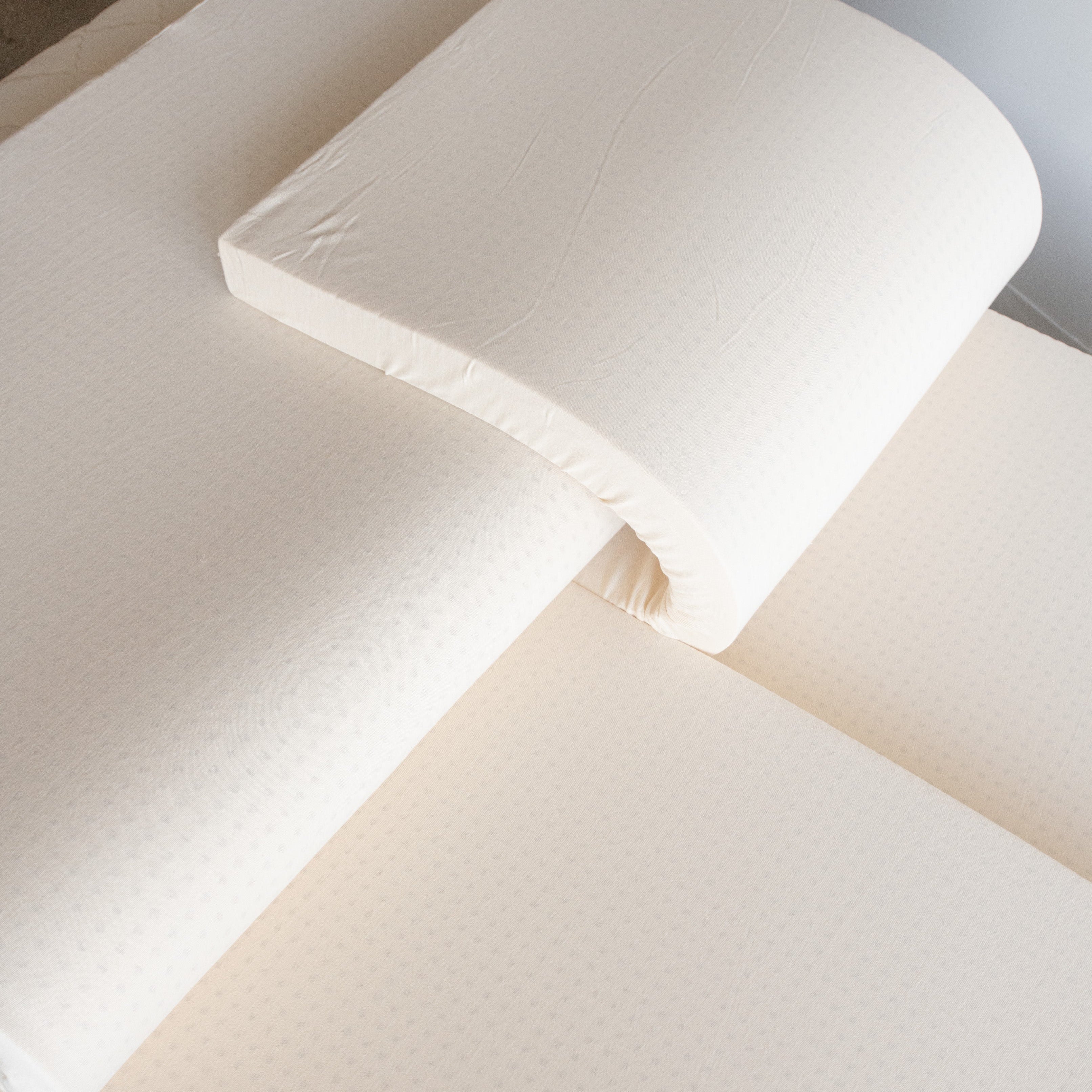 Kakun Organic Latex Layers - top and one middle layer rolled back halfway showing customization