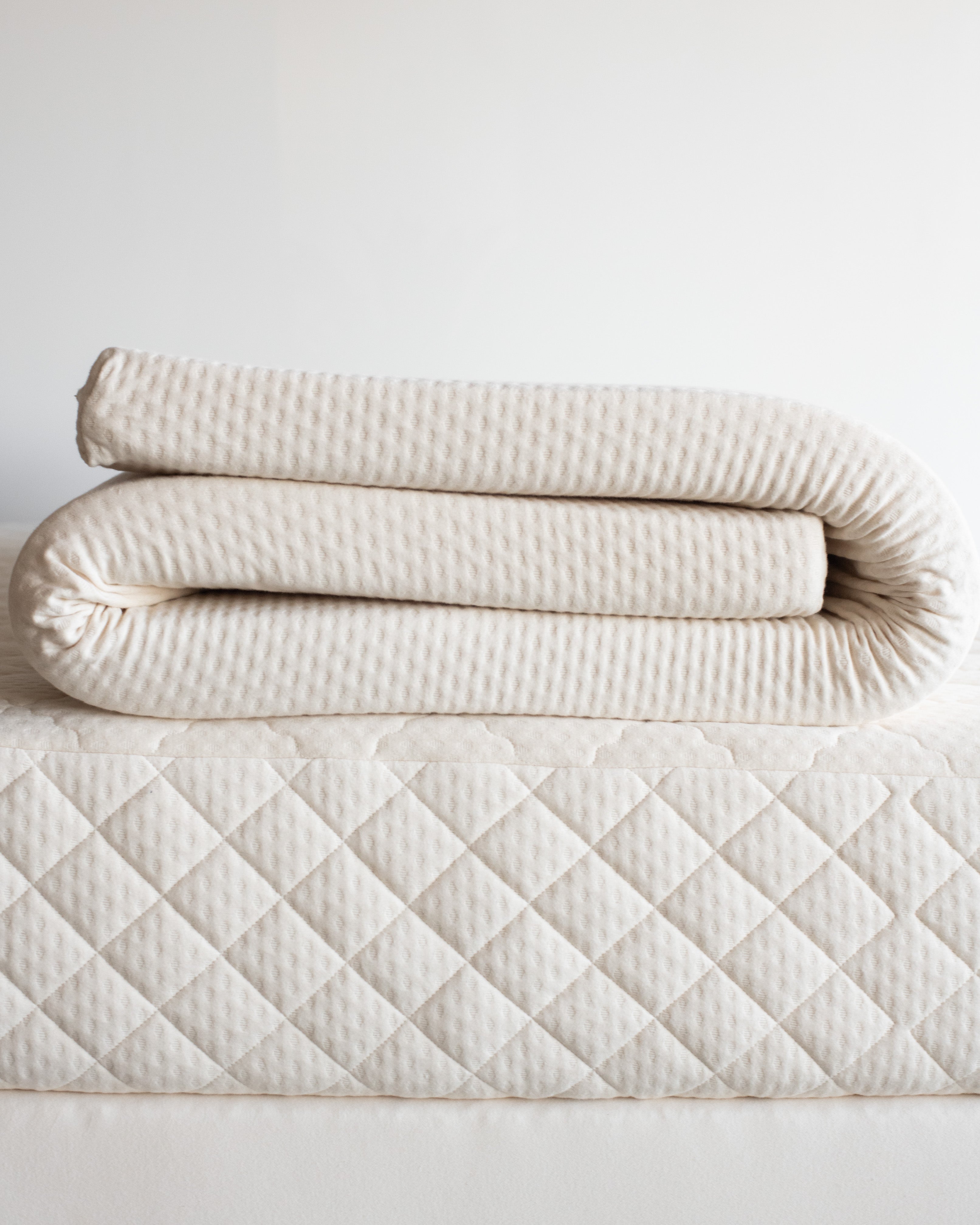 Kakun Organic Latex Mattress Topper - folded on top of mattress