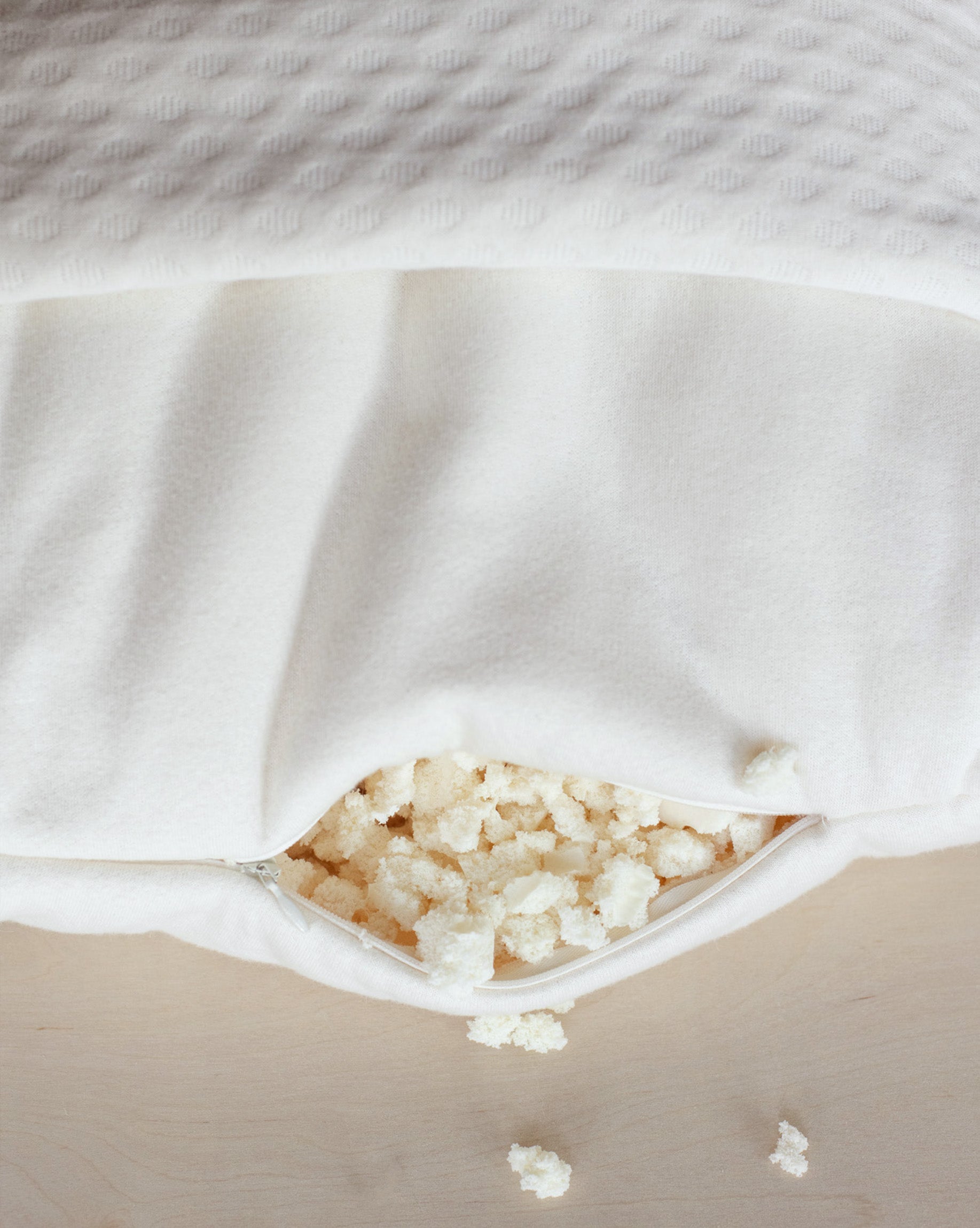 Kakun Organic Luxury Latex Pillow - close up of unzipped pillow, showing latex fill, inner encasement, and outer cover folded back.