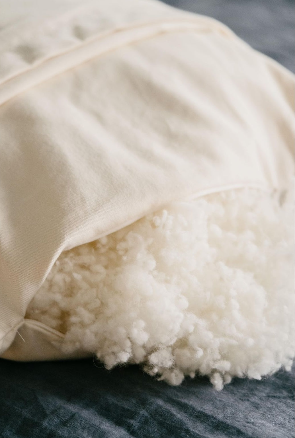 Kakun Organic Wool Pillow - close-up of unzipped pillow, showing wool fill texture.