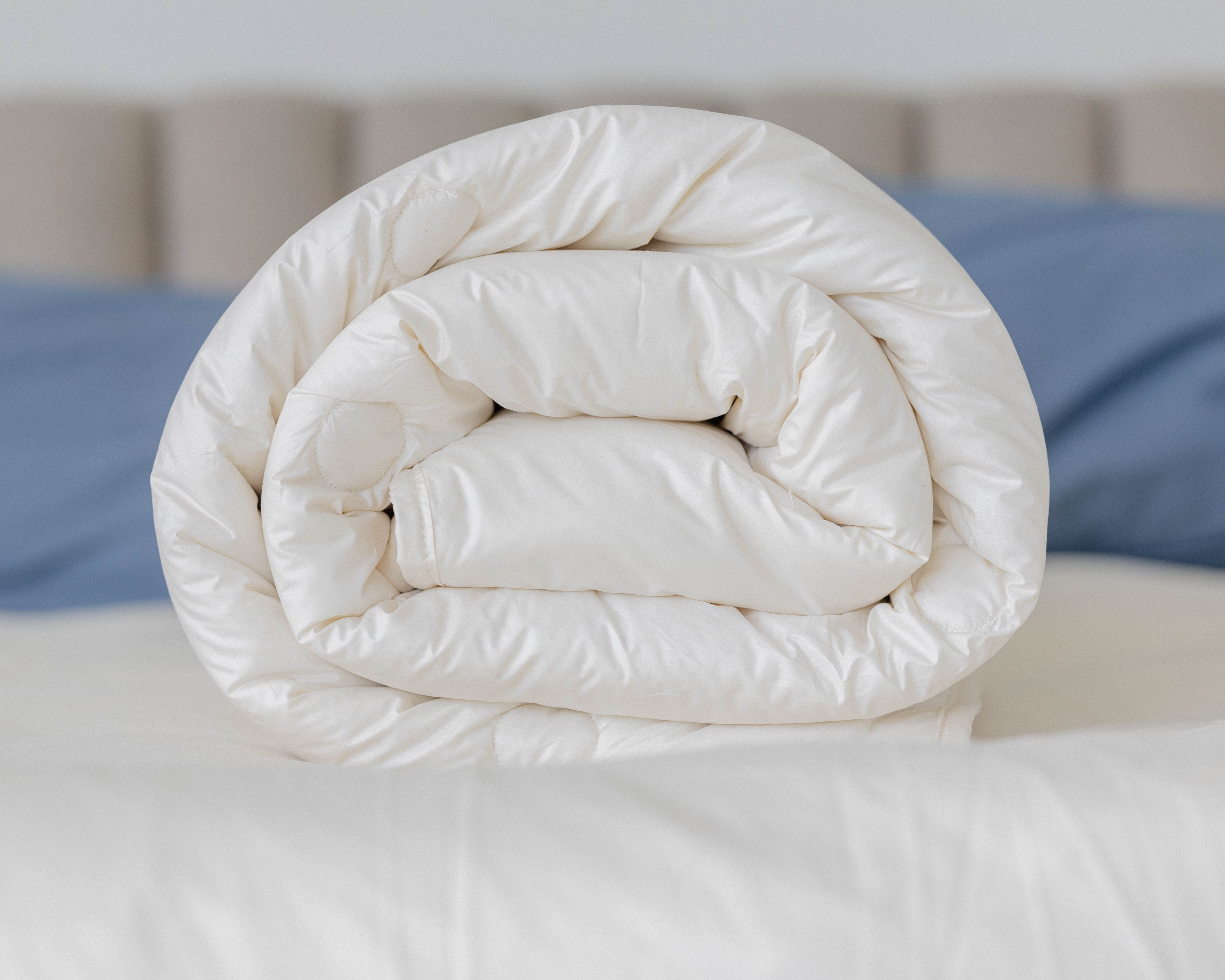 Kakun Organic Wool Comforter - rolled to display loft, and material texture.