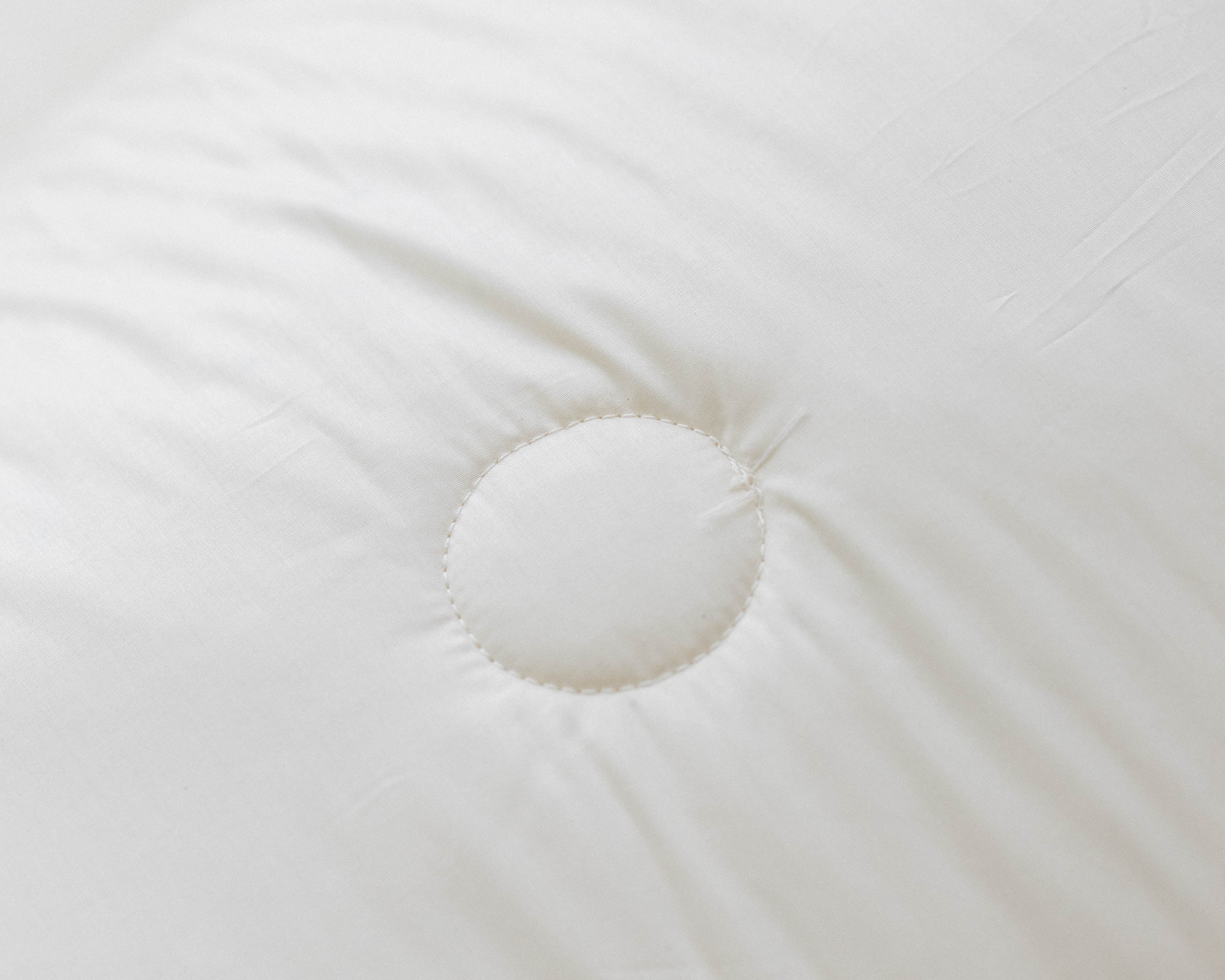 Kakun Organic Wool Comforter - close-up of stitching and smooth cotton casing texture.