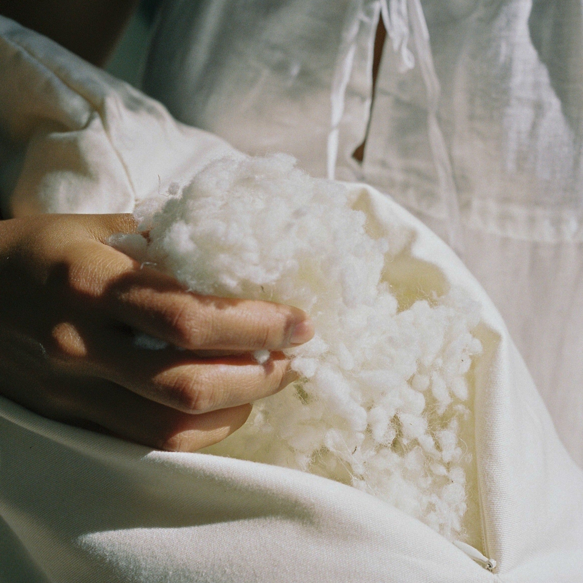 Kakun Organic Wool Pillow - close-up of unzipped pillow showing texture of wool fibres.
