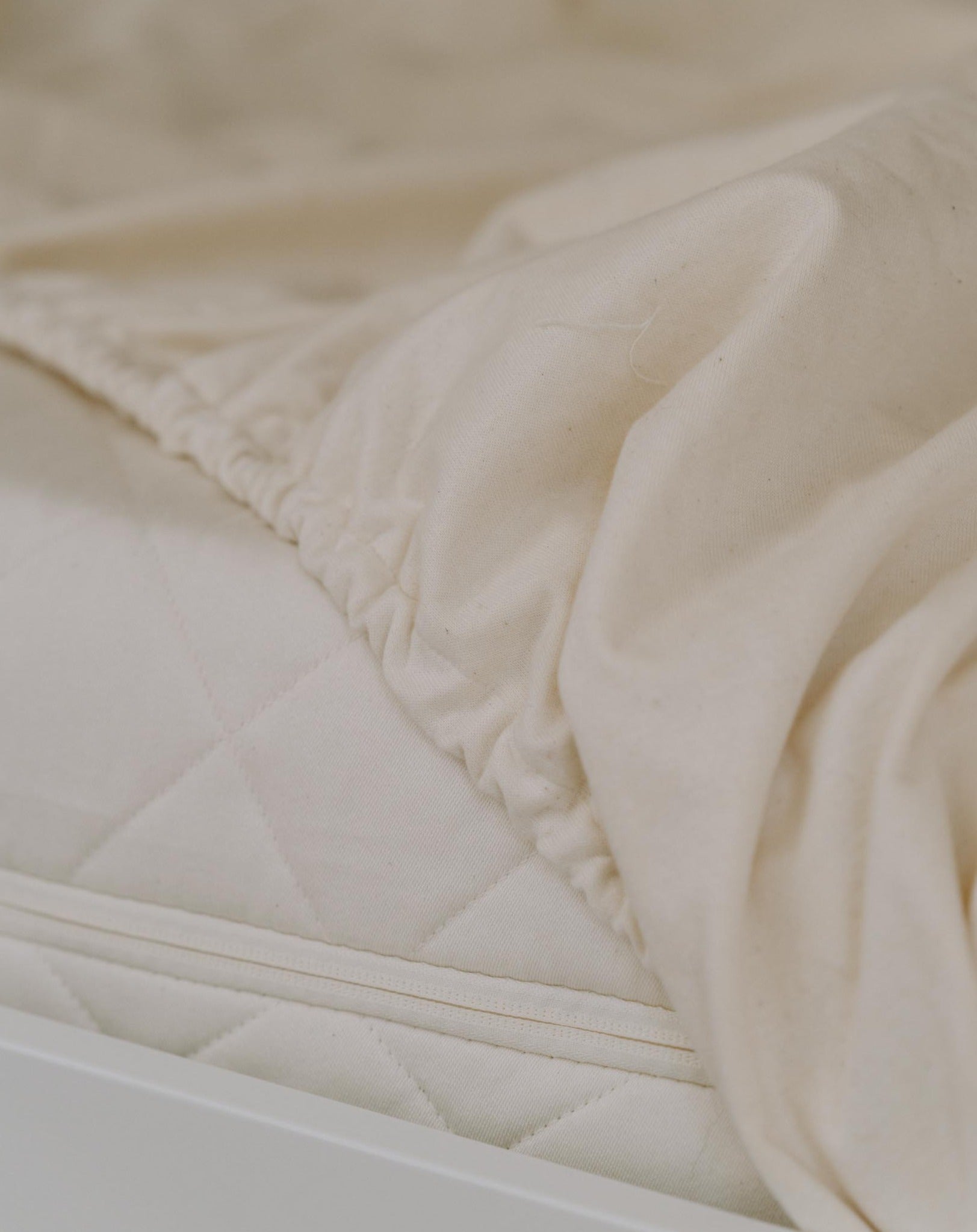 Kakun Waterproof Mattress Protector - loosely on bed showing edge elastic