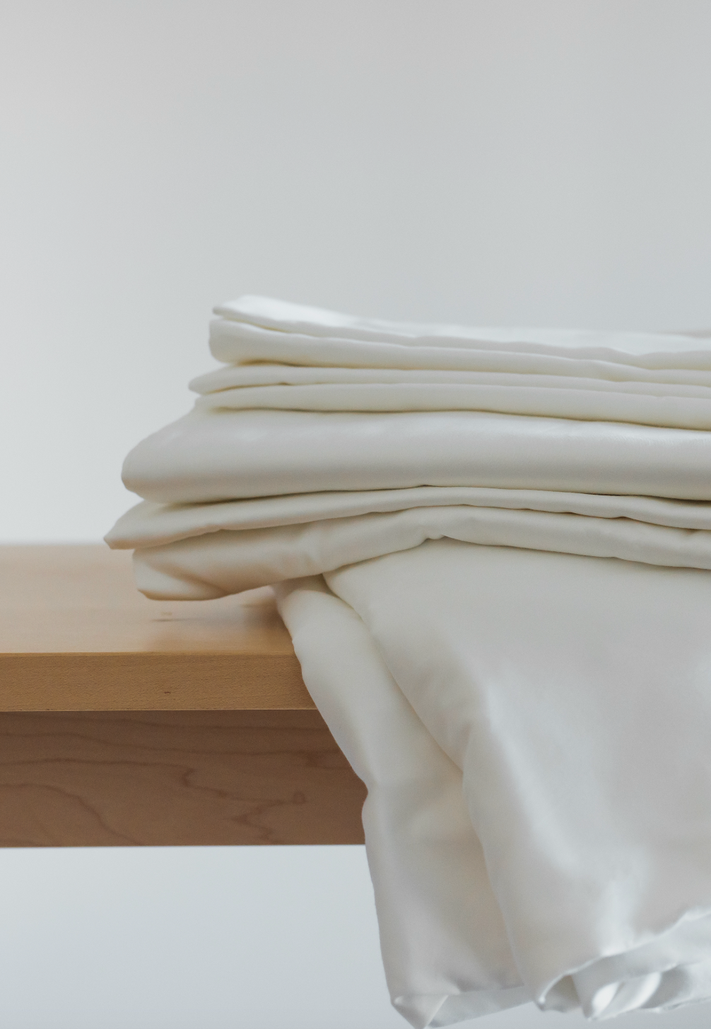 Obasan 400 Thread Count Sheet Set - white sheet set draped over wood bench