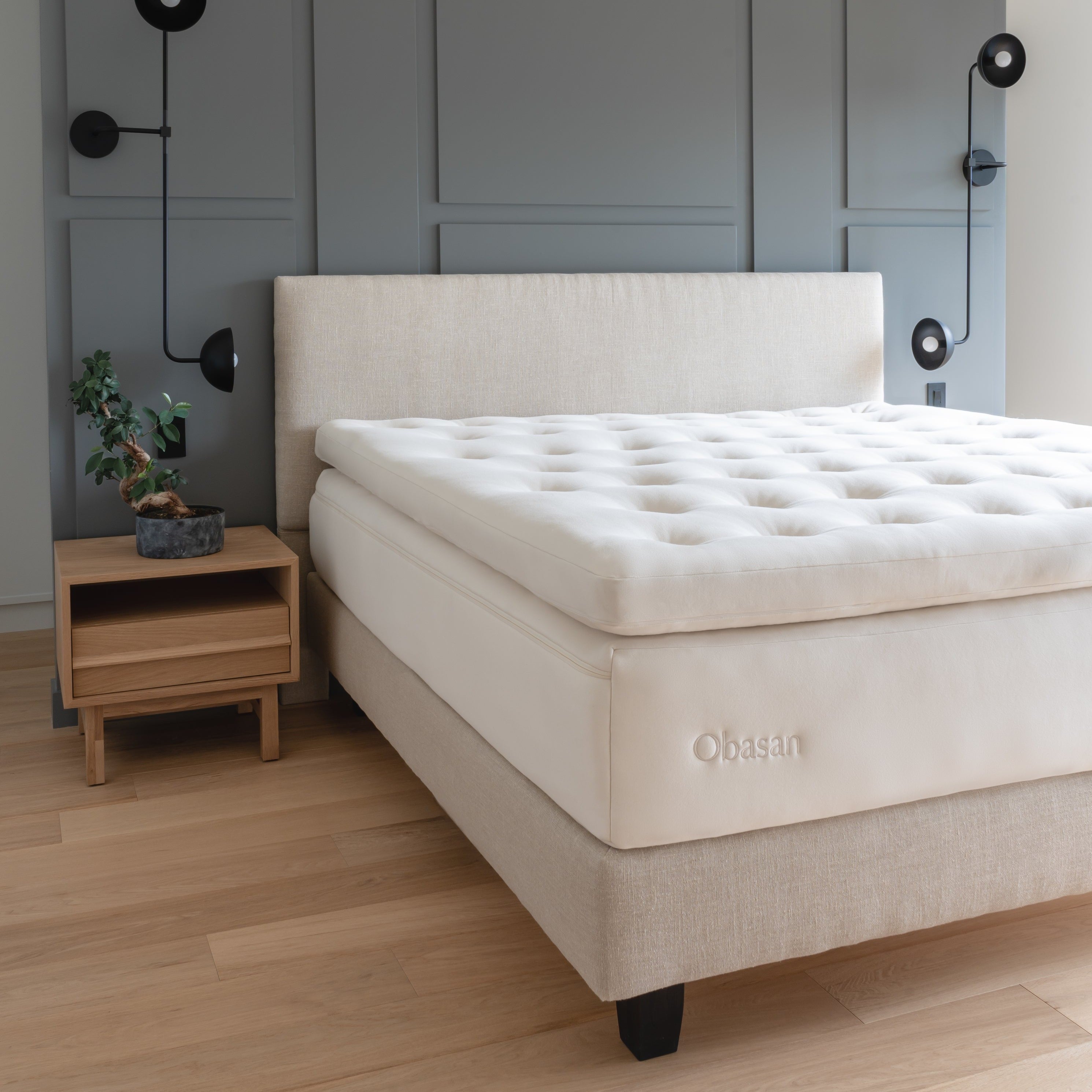 Obasan Deluxe Organic Mattress Topper - on matching bed in modern styled room with wall lamps