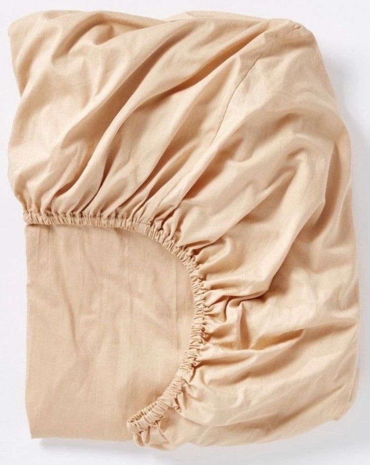 Coyuchi Cloud Soft Organic Sateen Fitted Sheet in Chai – folded, displaying elastic in seam. #colour_chai