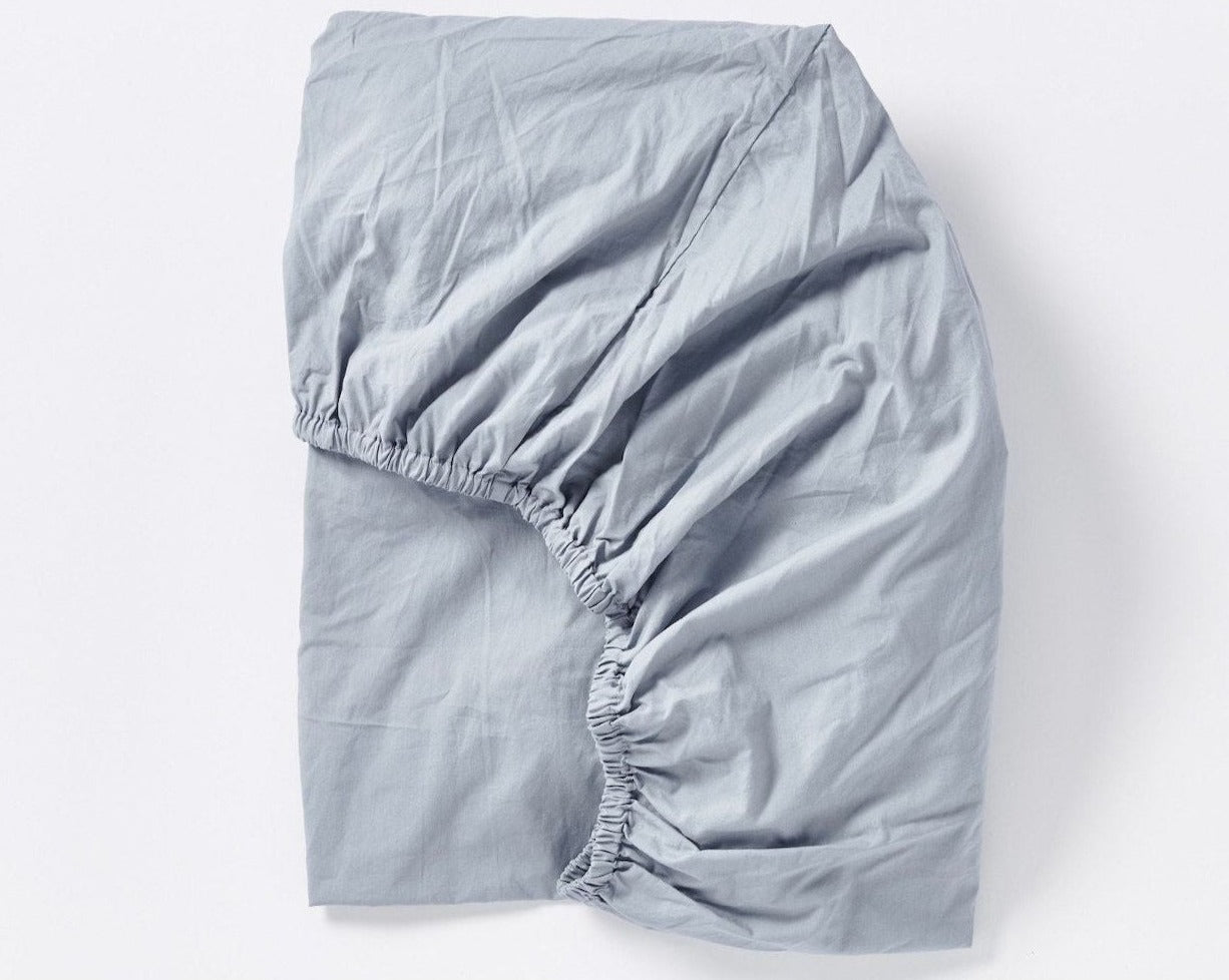 Coyuchi Organic Crinkled Percale Fitted Sheet in Steel blue – folded to display elastic in seam. #colour_steel blue