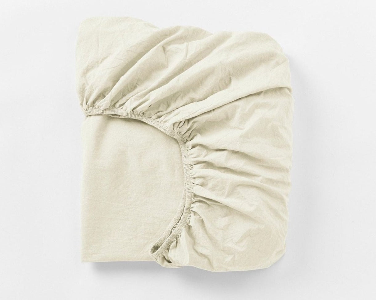 Coyuchi Organic Crinkled Percale Fitted Sheet in Undyed – folded to display elastic in seam. #colour_undyed