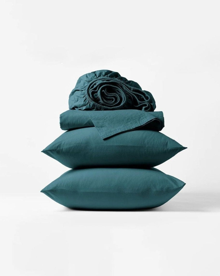 Coyuchi Organic Crinkled Percale Sheet Set in Aegean – stacked display with pillows and folded sheets. #colour_aegean