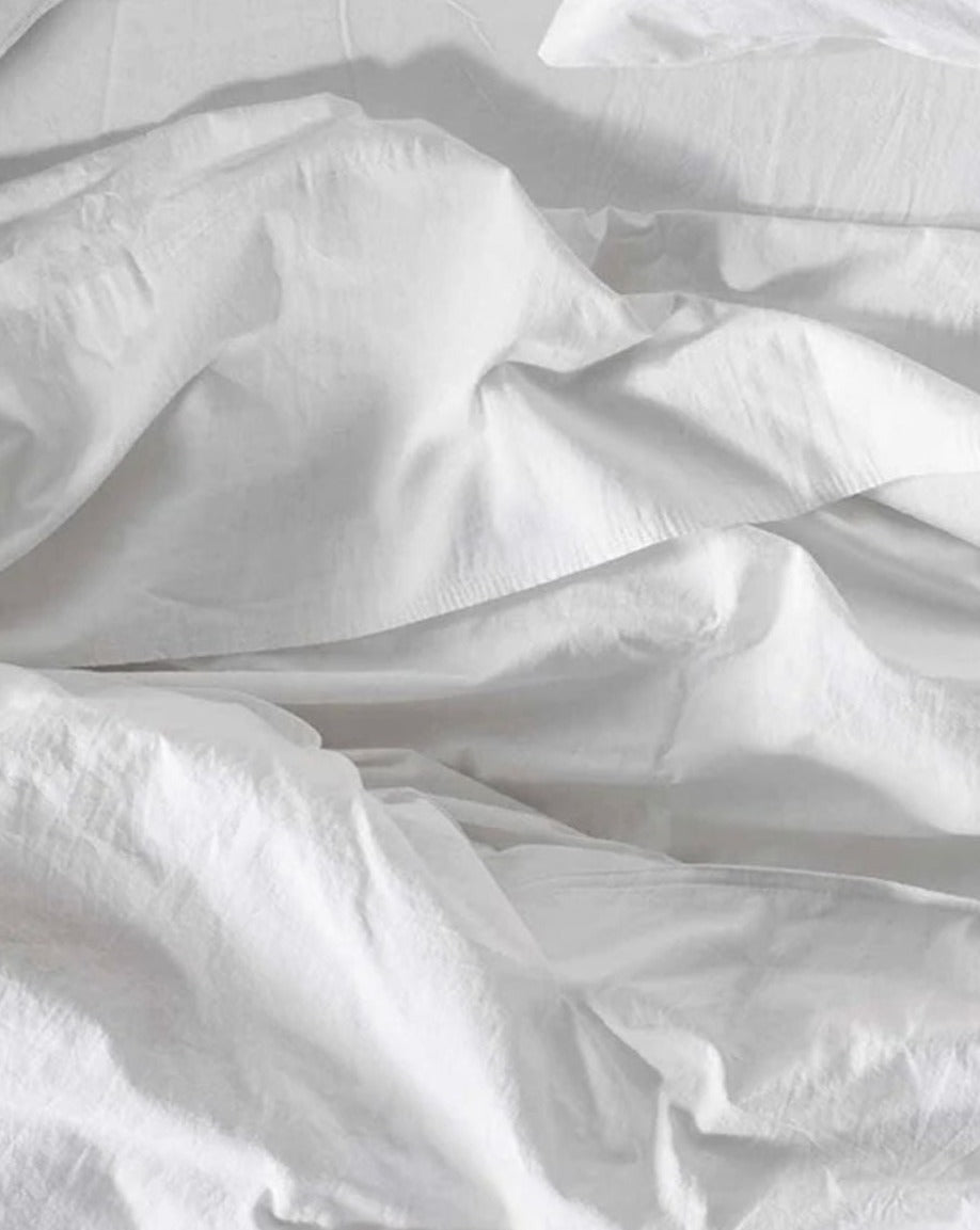 Coyuchi Organic Crinkled Percale Sheet Set in Alpine White – close-up showing texture quality and vibrancy of white. #colour_alpine white
