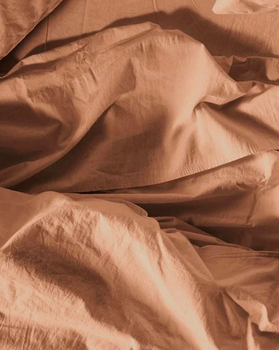 Coyuchi Organic Crinkled Percale Sheet Set in Ginger – close-up showing cotton texture quality and weave. #colour_ginger