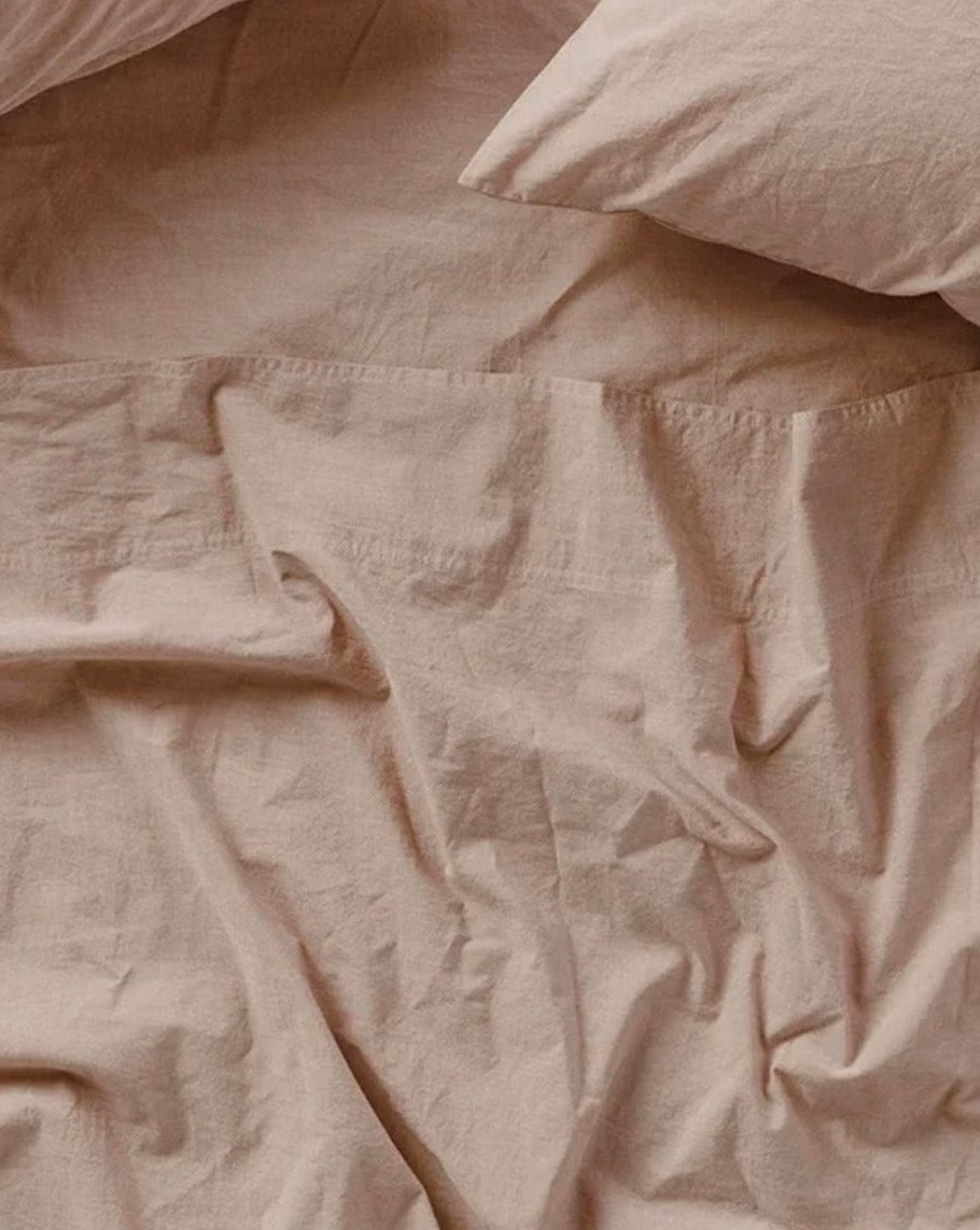 Coyuchi Organic Crinkled Percale Sheet Set in Hazel Chambray – close-up of cotton texture and stitching. #colour_hazel chambray