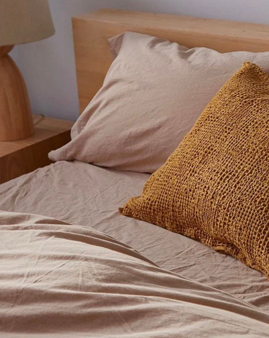 Coyuchi Organic Crinkled Percale Sheet Set in Hazel Chambray – detail shot displaying cotton texture on made bed. #colour_hazel chambray