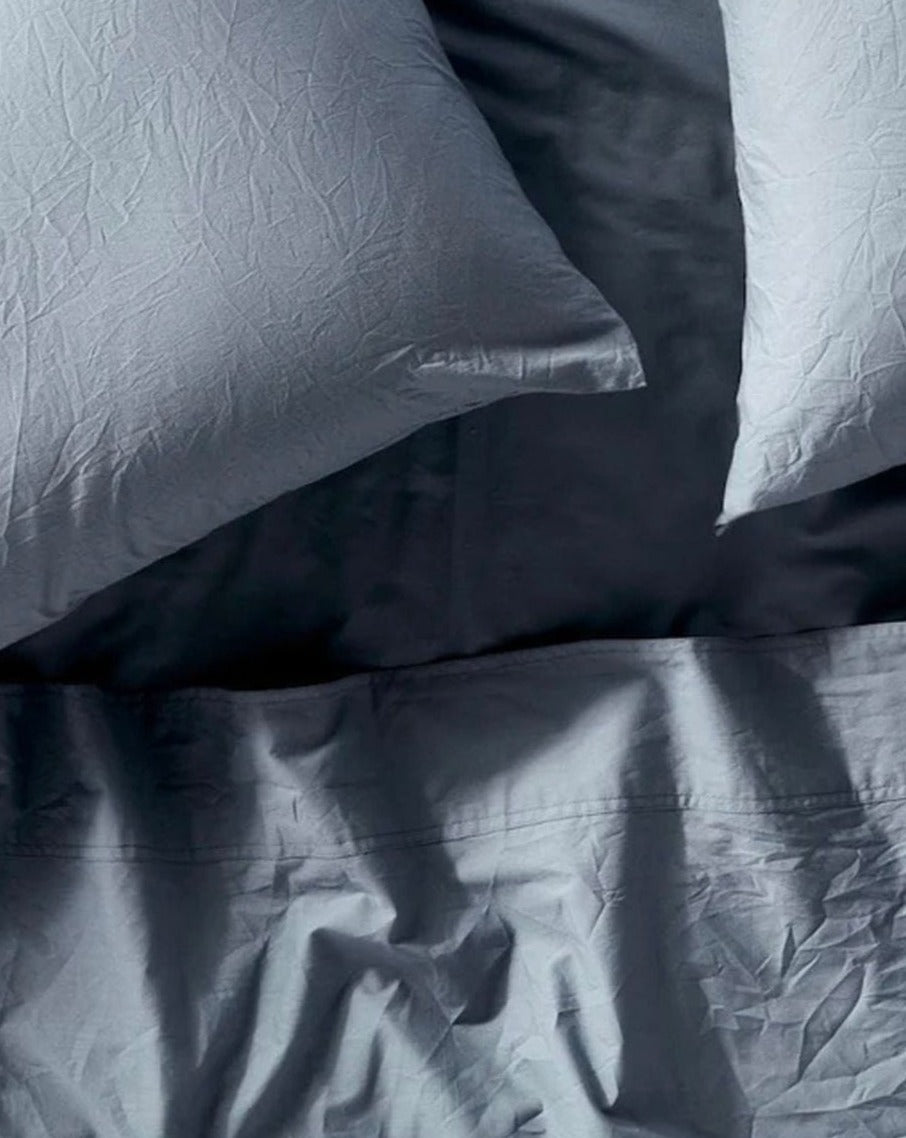 Coyuchi Organic Crinkled Percale Sheet Set in Steel Blue – close-up shot highlighting relaxed cotton texture. #colour_steel blue