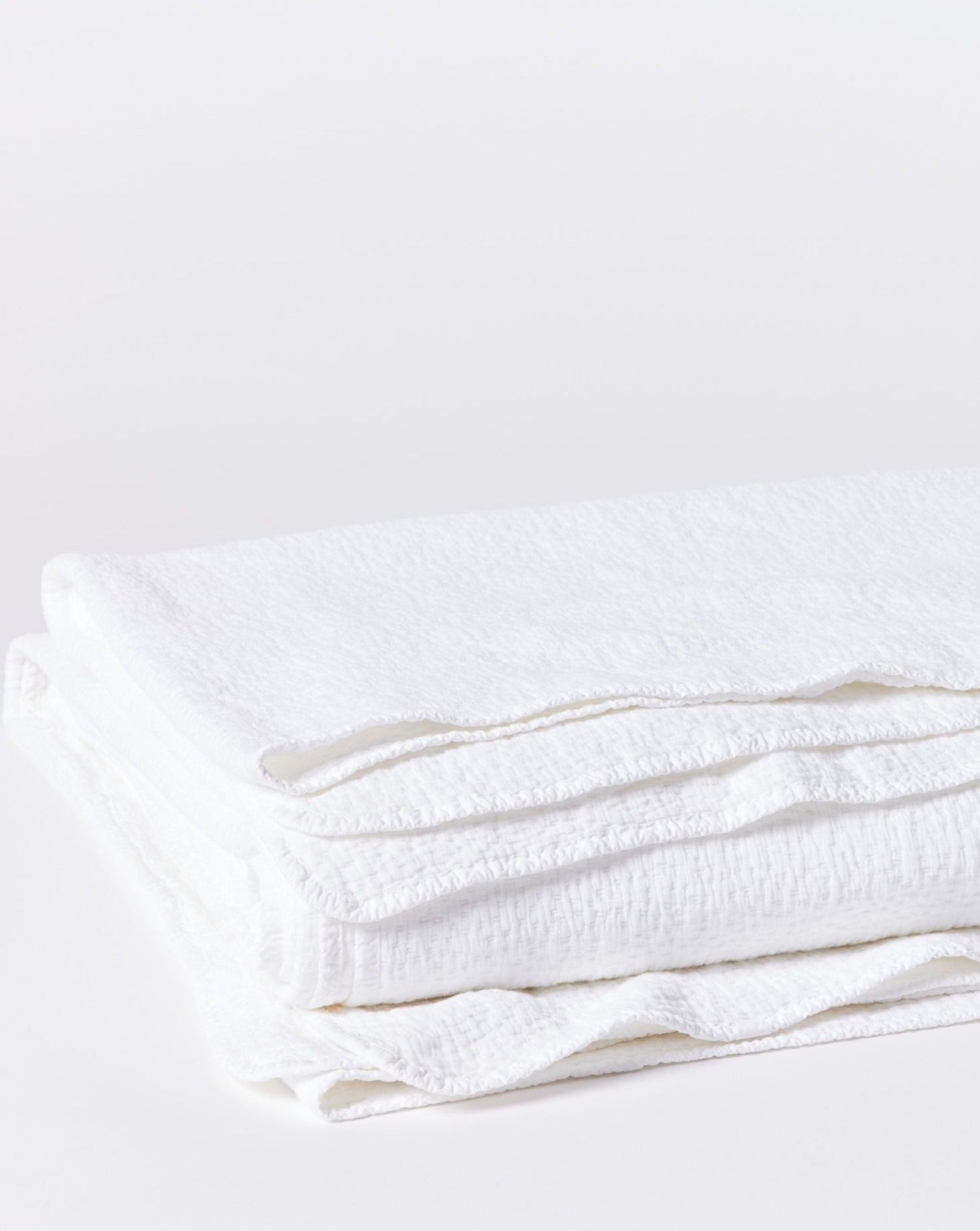 Coyuchi Organic Cascade Matelasse Blanket - folded #colour_Alpine White