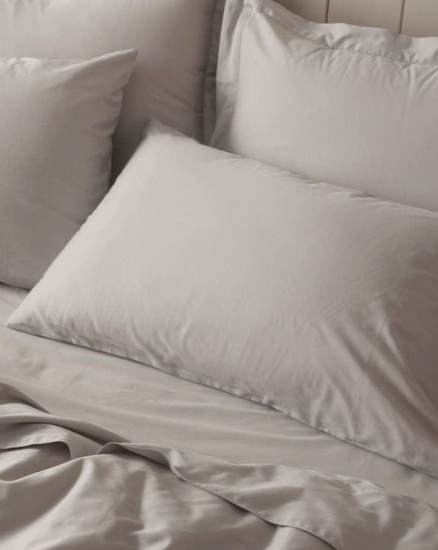 Coyuchi Organic Cloud Soft Sateen Duvet Cover - close up of pillows on staged bed #colour_pale gray
