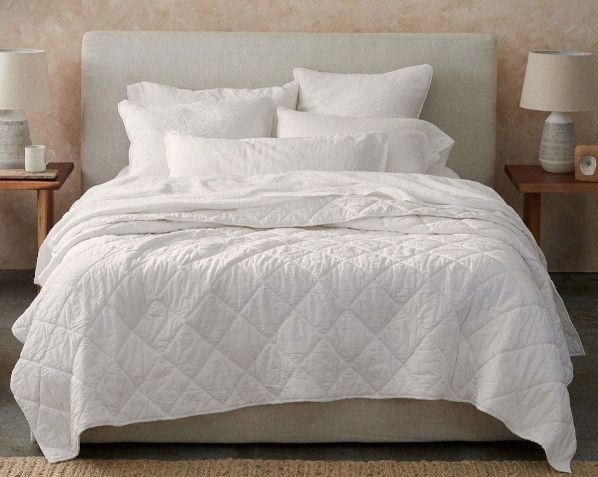 Coyuchi Organic Diamond Stitched Comforter - staged bed on linen frame #colour_alpine white