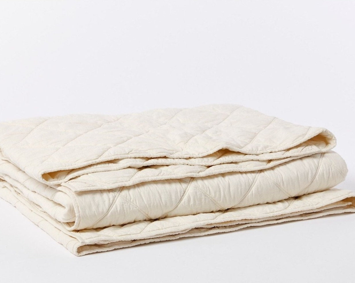 Coyuchi Organic Diamond Stitched Comforter - folded #colour_undyed