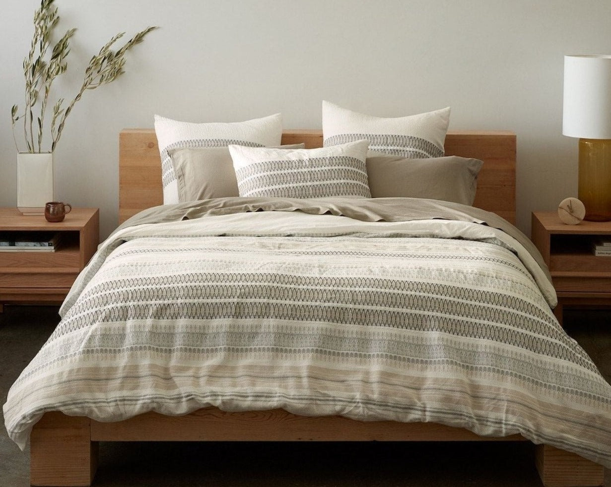 Coyuchi Organic Lost Coast Duvet Cover - staged bed with wood frame #colour_Soft White w/Deep Graphite