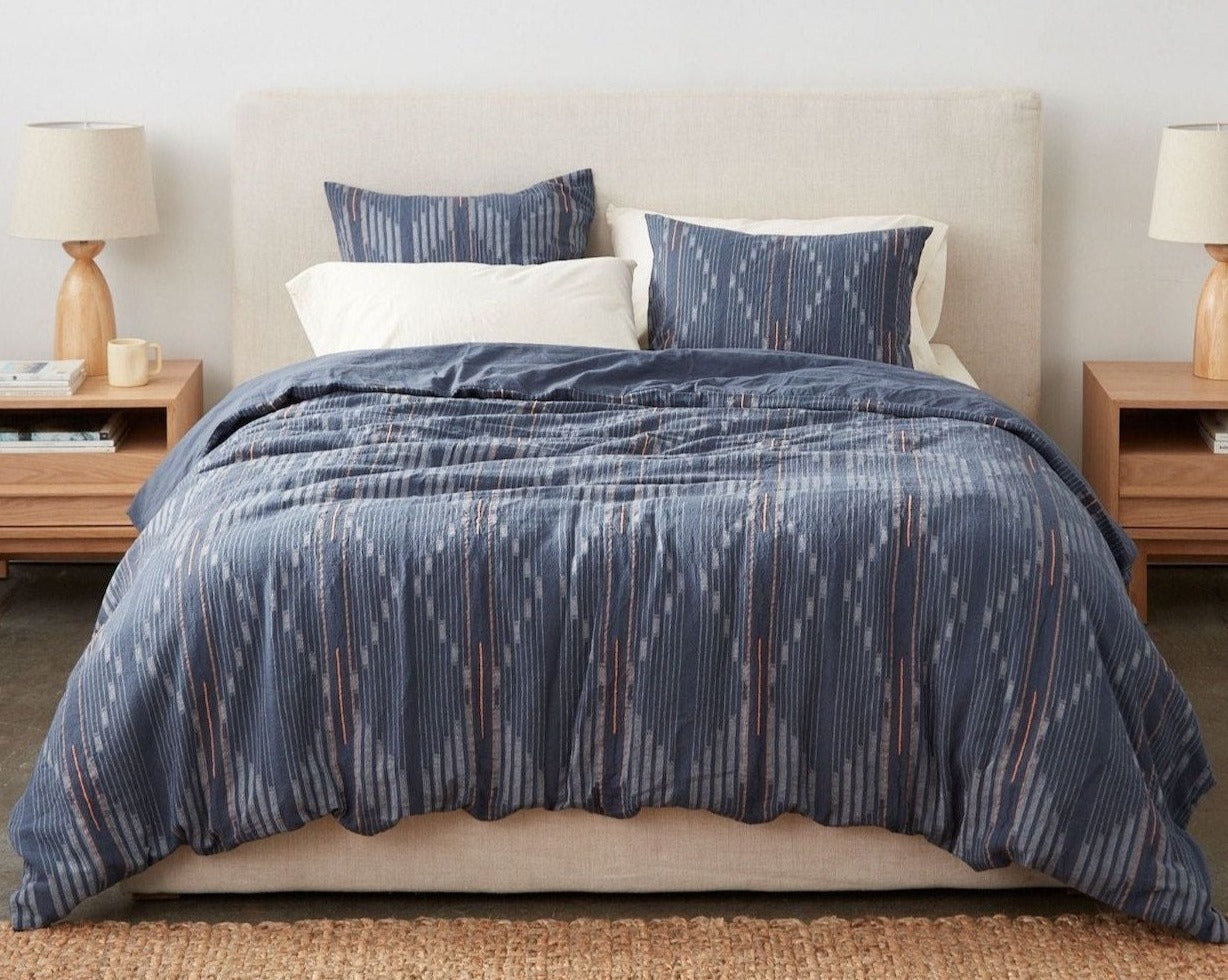 Coyuchi Organic Morelia Duvet Cover - staged bed with lamps on bedside table #colour_moonlight blue