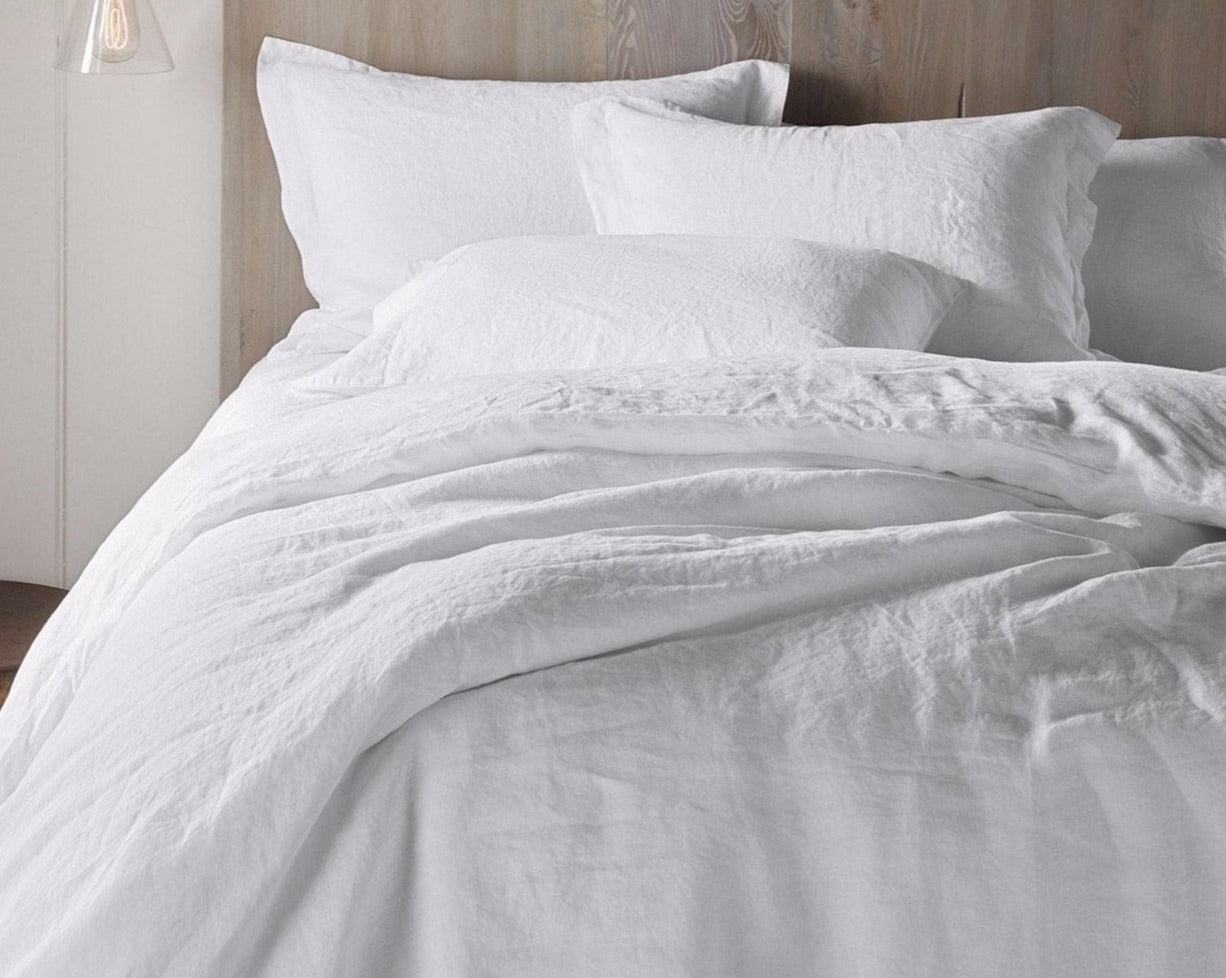Coyuchi Organic Relaxed Linen Pillowcases in Alpine White – made bed displaying rumpled linen texture. #colour_alpine white