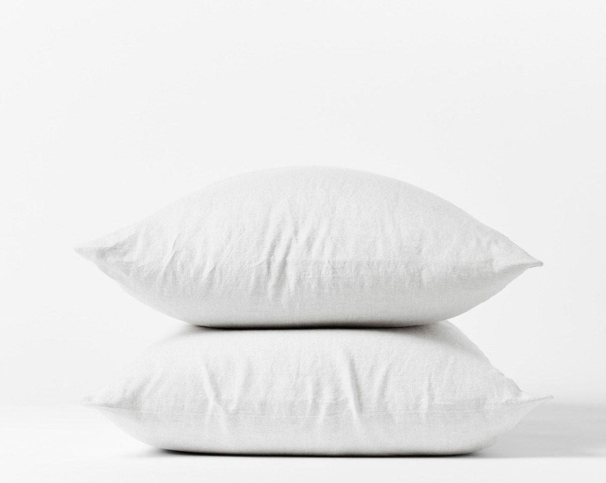 Coyuchi Organic Relaxed Linen Pillowcases in Alpine White – two stacked pillows, showing pillowcase fit and linen texture. #colour_alpine white
