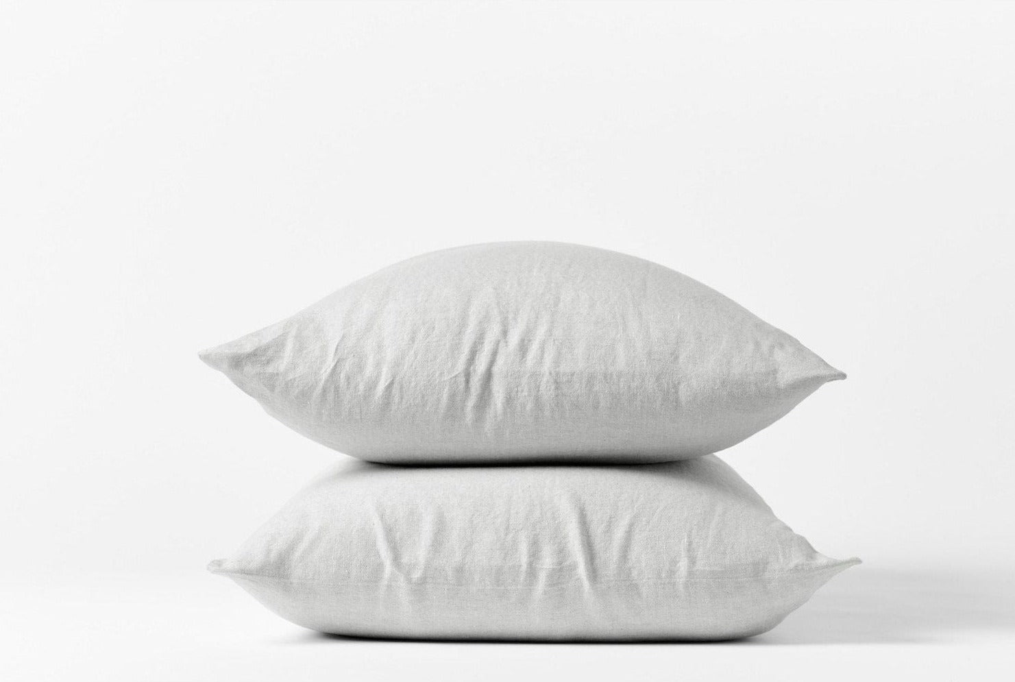 Coyuchi Organic Relaxed Linen Pillowcases in Fog – two stacked pillows, showing pillowcase fit and linen texture. #colour_fog