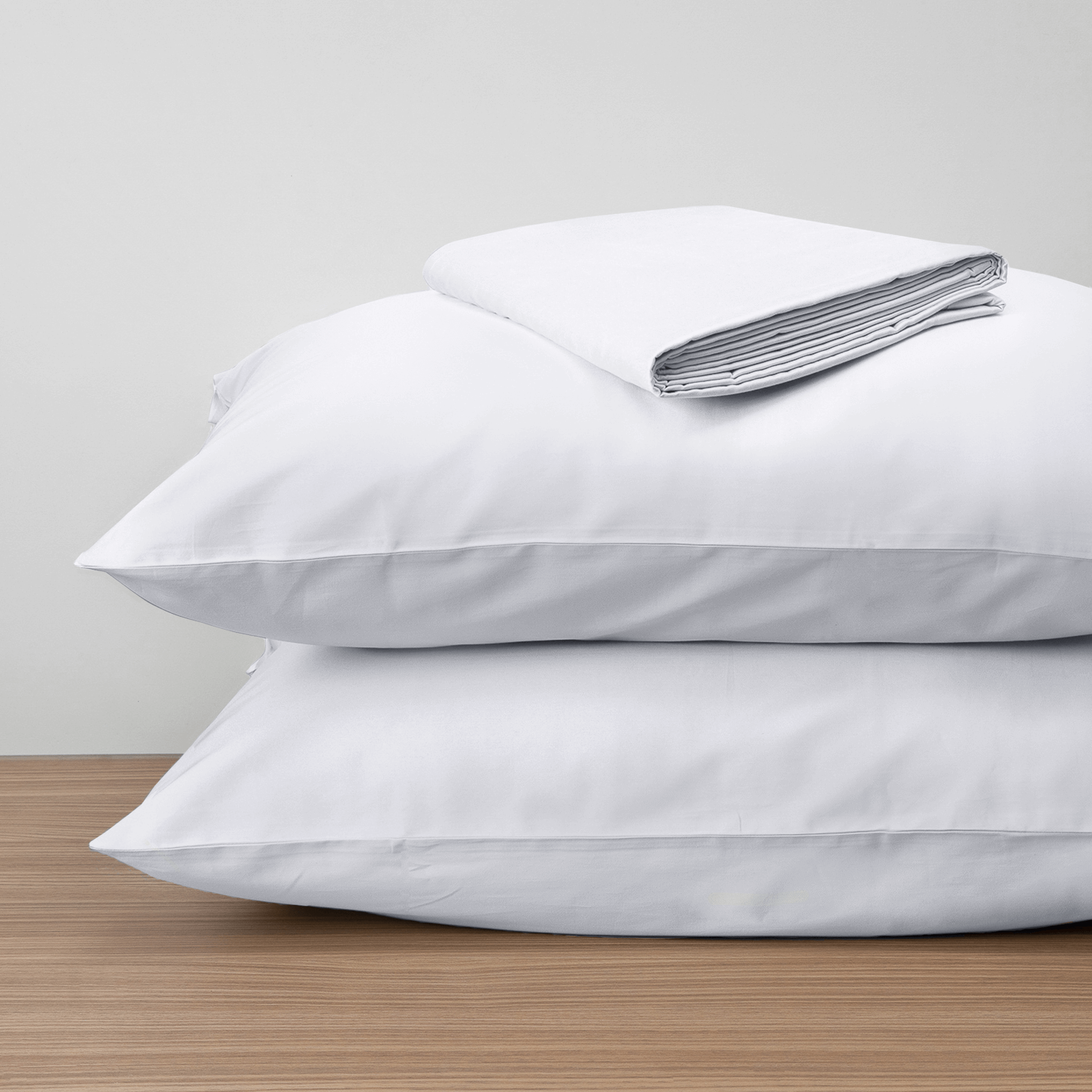 Homebird Organic Cotton Sateen Fitted Sheet and Pillowcases - on pillows #colour_white