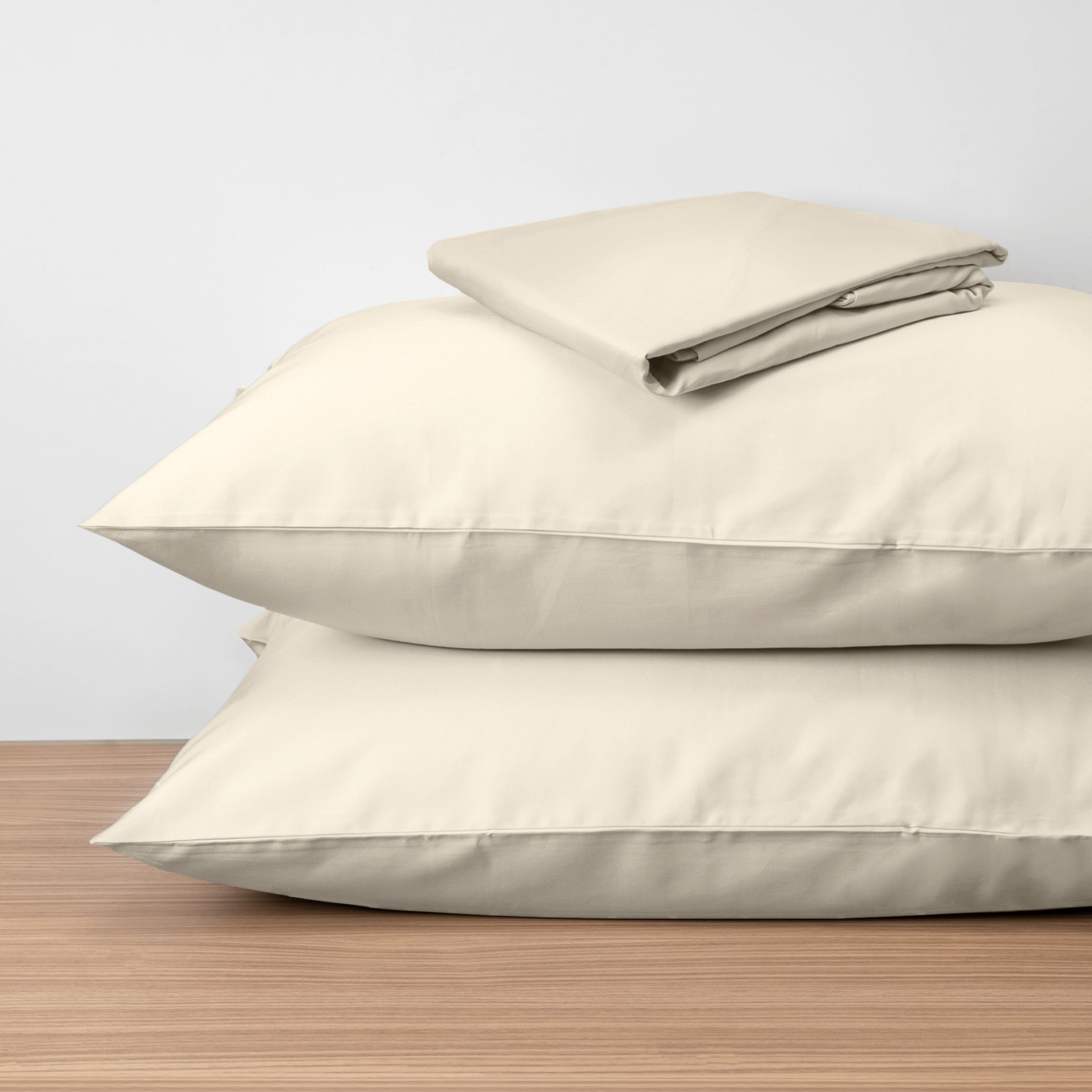 Homebird Organic Cotton Sateen Fitted Sheet and Pillowcase - on pillows #colour_sandy white