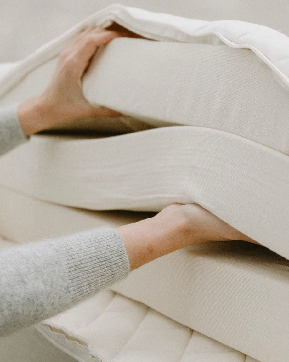 Kakun Organic Latex Mattress - unzipped cover with model separating layers by hand