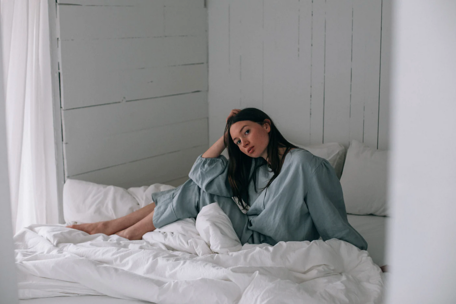 woman in bed with white duvet