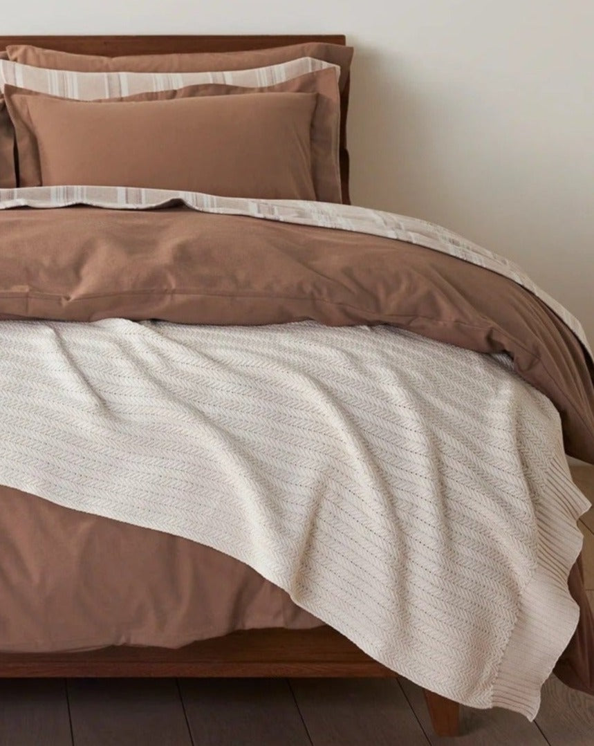 Casa Loma Knit Thow Undyed laying over Ginger Crinkled Percale Duvet Cover