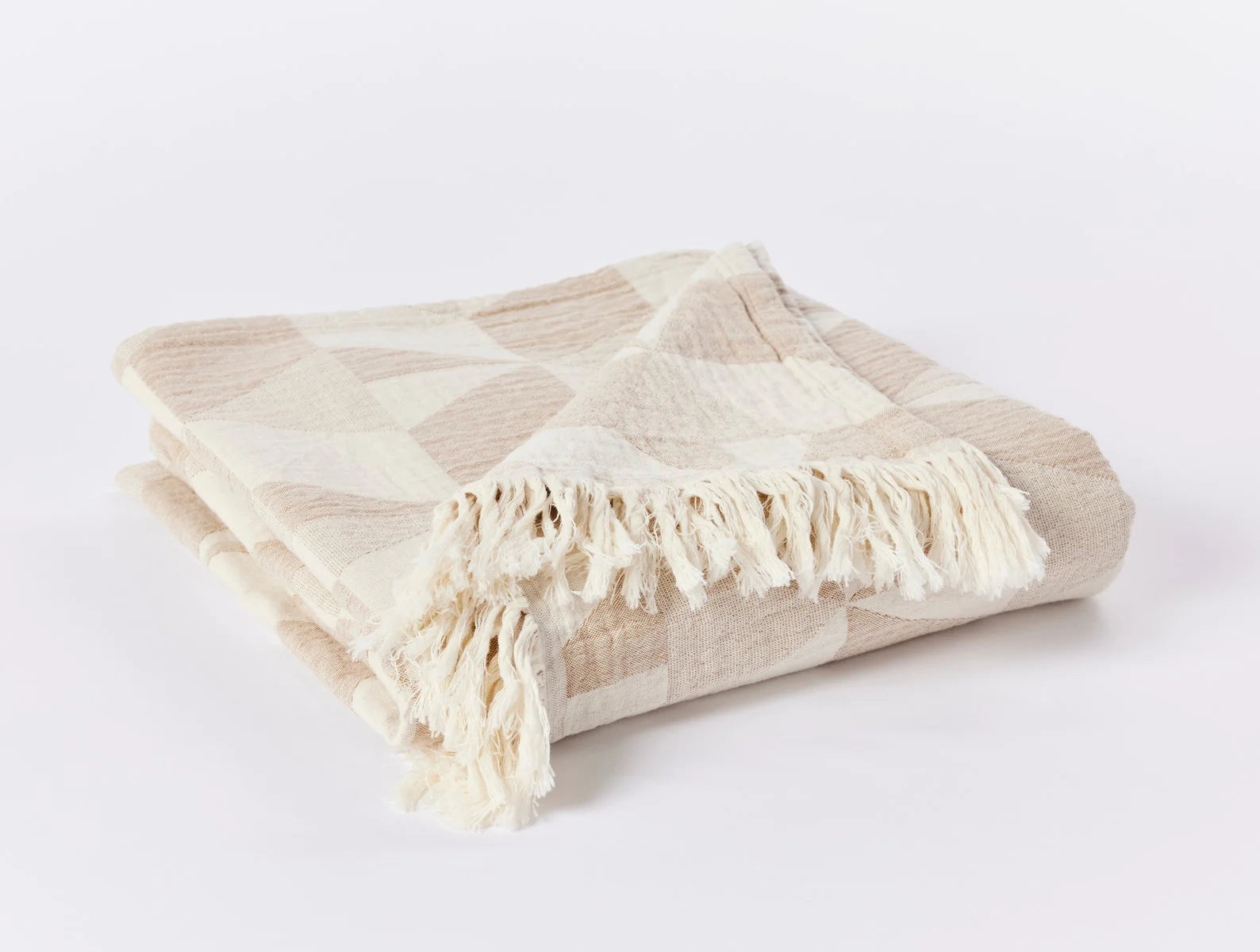 Pismo Organic Cotton Throw in Hazel folded to show off the 2.5" fringe on the top and bottom. Bright, white background.
