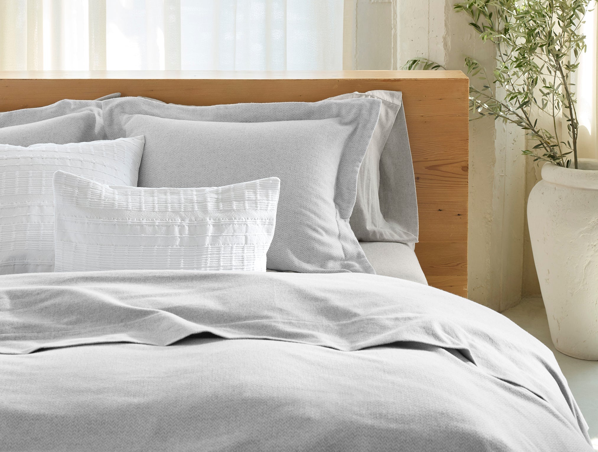 Coyuchi Cloud Brushed Organic Flannel Texture Duvet Cover - staged bed focus on matching pillows #colour_pale gray heather