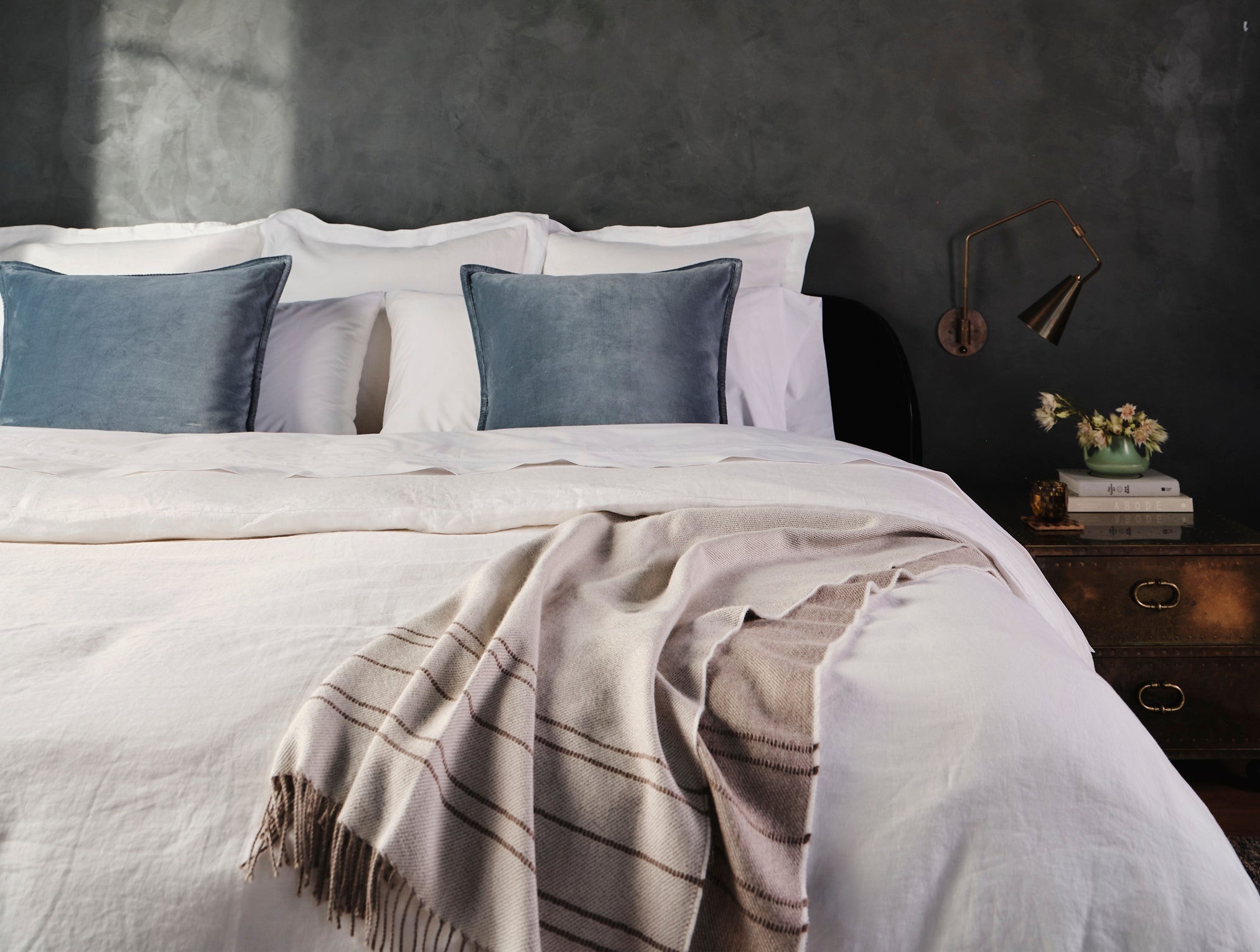 Coyuchi Lima Reversible Alpaca Throw - draped over made up bed #colour_Ivory/Camel