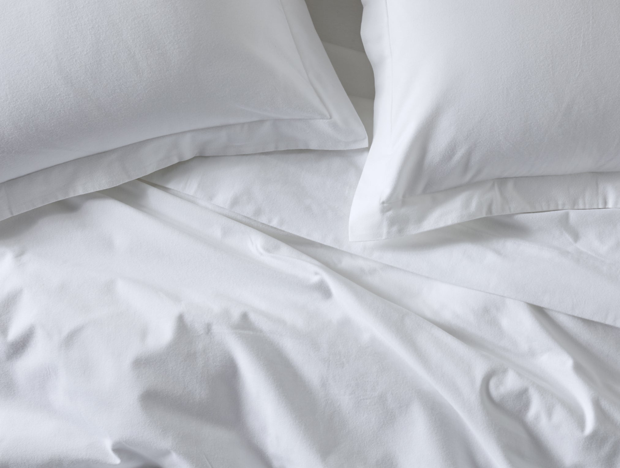 Coyuchi Organic Cloud Brushed Flannel Duvet Cover - staged bed close up with matching pillows #colour_alpine white