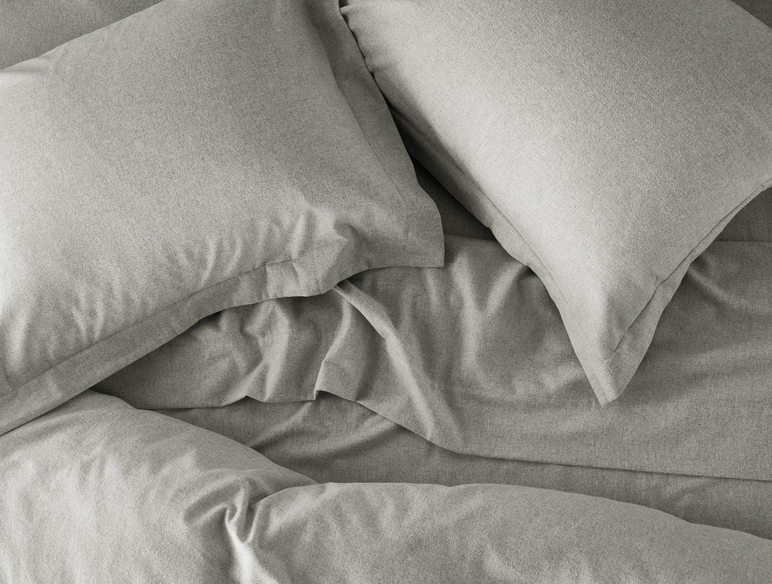 Coyuchi Organic Cloud Brushed Flannel Duvet Cover - close up of matching pillows and sheet set #colour_pale gray heather
