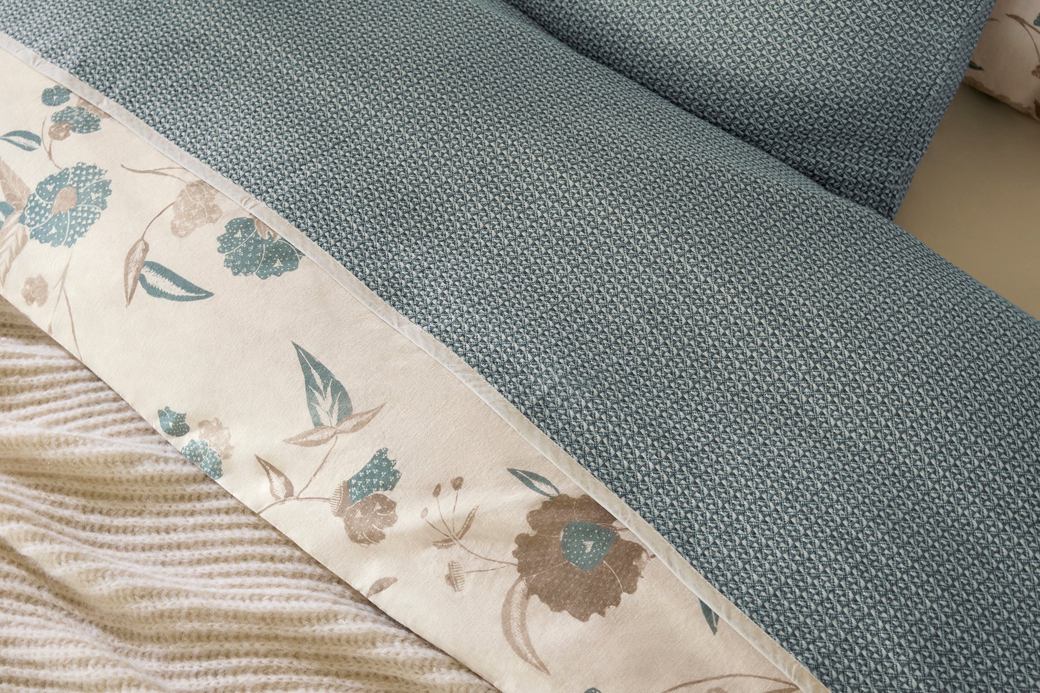 Coyuchi Organic Cotton Honeycomb Blanket - close up with matching pillow and flower duvet #colour_Undyed Lagoon