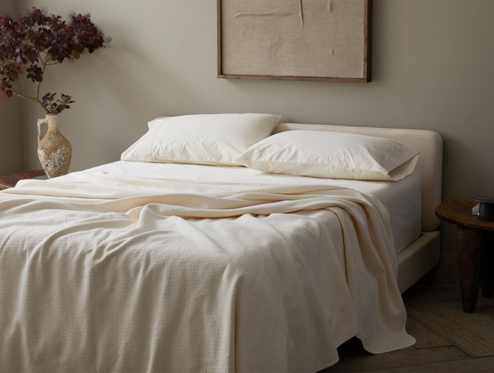 Coyuchi Organic Cotton Honeycomb Blanket - staged bed with vase and flowers on side table #colour_undyed