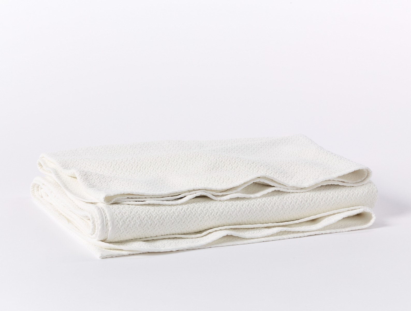 Coyuchi Organic Cotton Honeycomb Blanket - folded #colour_white