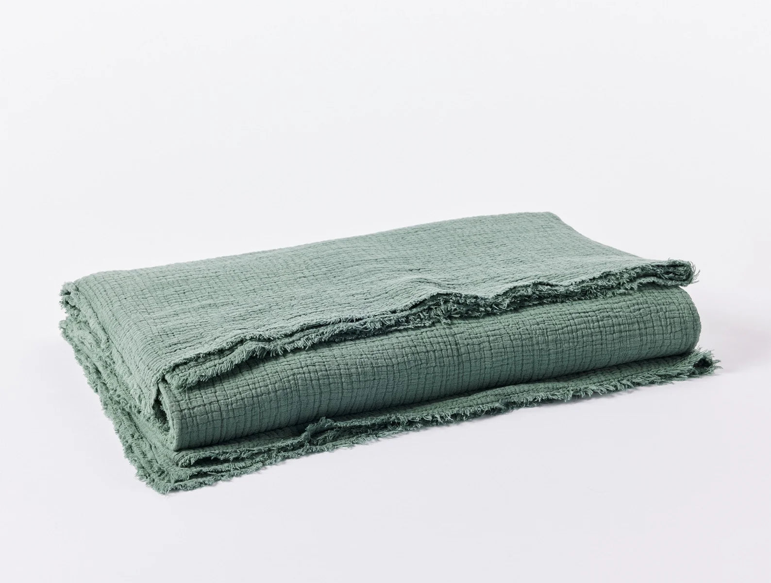 Coyuchi Organic Cotton Topanga Matelasse Blanket - folded #colour_juniper