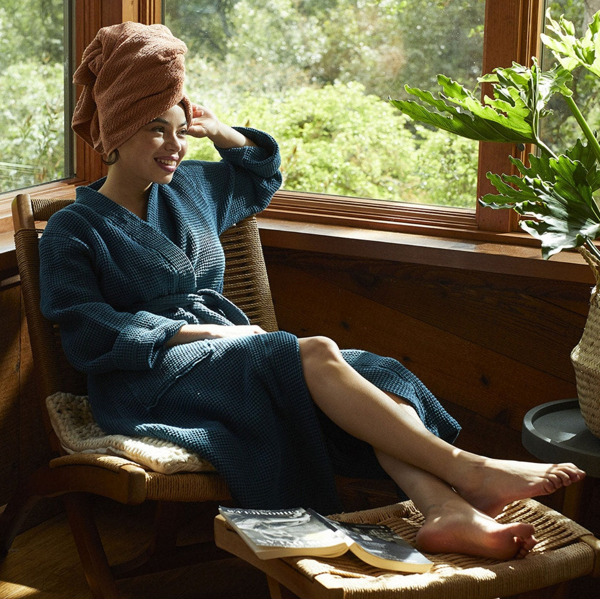 Coyuchi Organic Cotton Unisex Waffle Robe - model wearing with large window and natural lighting #colour_deep ocean