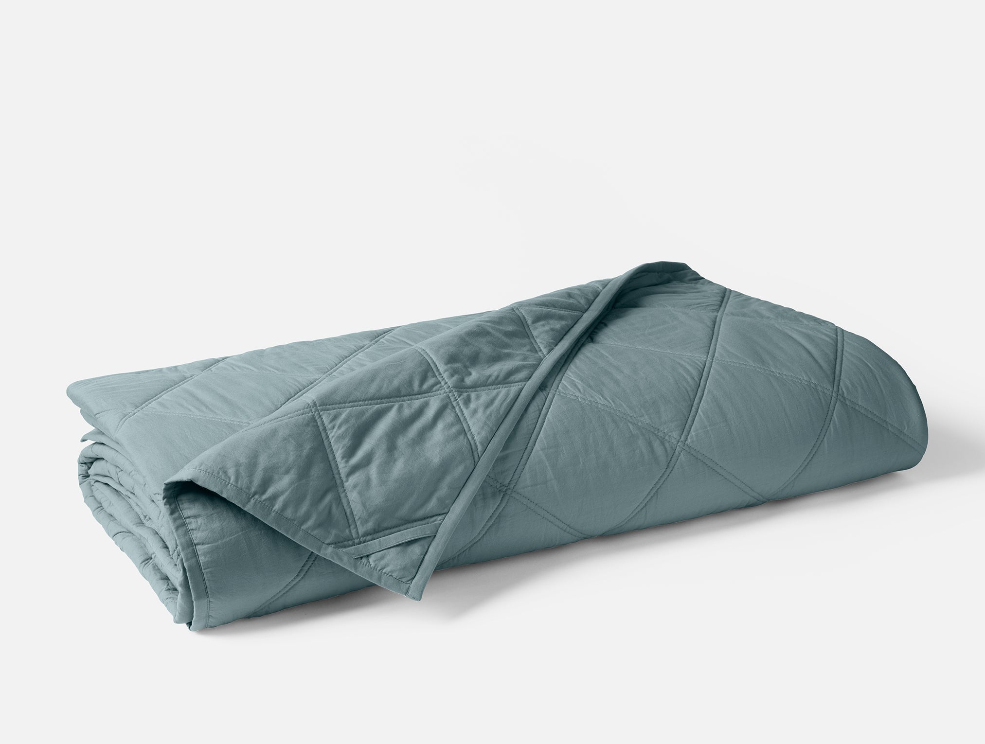 Coyuchi Organic Diamond Stitched Comforter - folded #colour_Lagoon